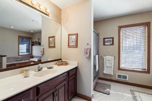 a bathroom with a sink and a large mirror at Laurel Springs Retreat in Nellysford +33 photos