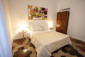 a bedroom with a white bed and two tables at Stella Maris B&B in Brescia +3 photos