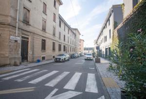 a street with cars parked on the side of a building at Stella Maris B&B in Brescia