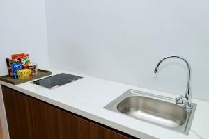 a kitchen sink with a faucet on a counter at Maya Hotel in Bản Giang