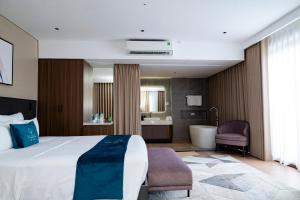 a hotel room with a large bed and a bathroom at Maya Hotel in Bản Giang