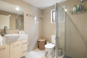 a bathroom with a toilet and a sink and a shower at Smart Suites Self Check-in Apartments - Sunnybank Station in Brisbane +51 photos