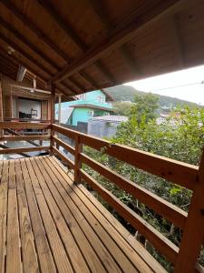 a wooden deck with a view of the ocean at Voila Hostel in Florianópolis