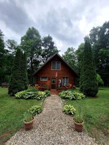 a small house with a pathway in front of it at Charming Creekside Log Cabin with Wood Burning Stove Overlooking the Neshannock Creek, Western PA in Volant