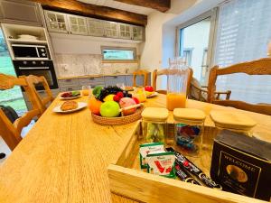 a kitchen with a wooden table with fruits and vegetables on it at L'échappée belle - Maison - Proche Le Creusot in Marmagne
