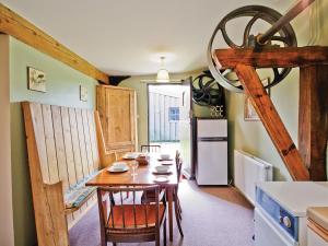 a dining room with a table and a refrigerator at The Granary - E3669 in Saxtead