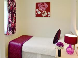 Saint CleerにあるTrevarno - B6527のベッドとランプ付きのテーブルがある寝室