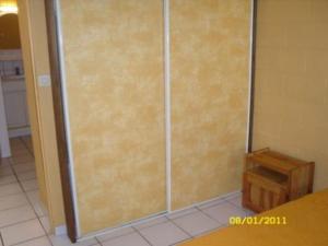 a shower stall in a bathroom with a wooden stool at laréunion in Maison Henou +2 photos