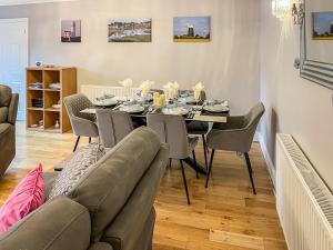 a dining room with a table and chairs at Rivendell Lodge - Cottage in East Winch