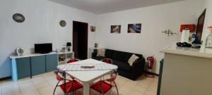 a living room with a table and a couch at L'approdo in Schisò