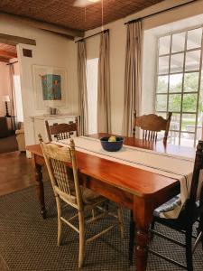a dining room table with a bowl of fruit on it at Ashbourne Country Escape Hazyview in Hazyview