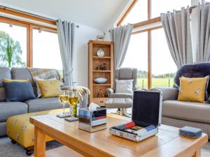 a living room with a couch and a table at Sunnyside House in Duthil