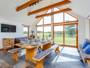 a dining room with a table with glasses on it at Sunnyside House in Duthil +26 photos