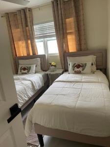 a bedroom with two beds and a window at My Relaxing place! in North Fort Myers