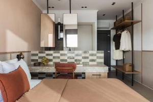 a bedroom with a bed and a kitchen at Orizon Boutique Rooms in Kalamitsi