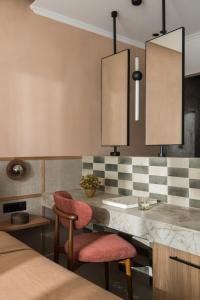 a kitchen with two chairs and a counter with two lights at Orizon Boutique Rooms in Kalamitsi +37 photos