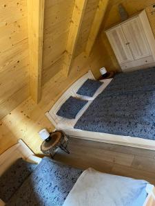 an overhead view of two beds in a wooden cabin at chata Malina in Martin