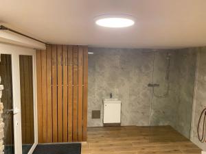 a bathroom with a shower with a glass door at chata Malina in Martin +9 photos