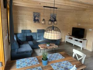 a living room with a blue couch and a table at chata Malina in Martin