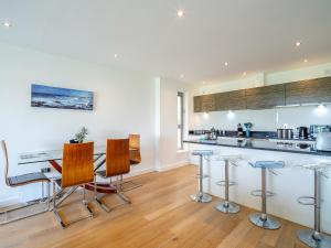 a kitchen with a bar and some chairs at 7 Cribbar in Newquay