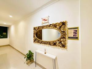 a gold mirror on a wall in a room at The Raden Patah Heritage Kota Lama Semarang in Semarang
