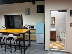 a kitchen with a table and a refrigerator at 流浪秘境Wanderland in Green Island
