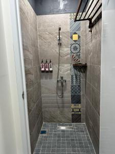 a bathroom with a shower with a tiled floor at 綠島走走 in Green Island +12 photos