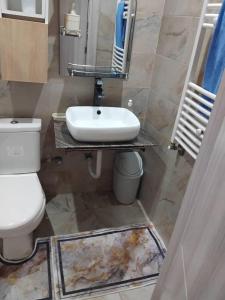 een badkamer met een wastafel en een toilet bij Houcine appartement in 'Aïn el Turk