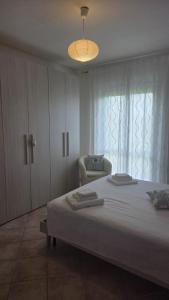 a bedroom with a bed and a chair and a window at Casa Adelaide - A stone's throw from Rome in Gavignano
