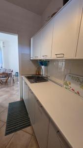 a kitchen with white cabinets and a counter top at Casa Adelaide - A stone's throw from Rome in Gavignano