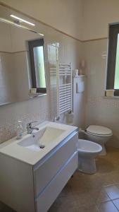 a white bathroom with a sink and a toilet at Casa Adelaide - A stone's throw from Rome in Gavignano +21 photos
