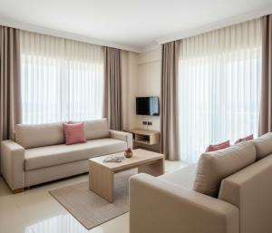 a living room with two couches and a tv at MyHome Apart Antalya in Antalya
