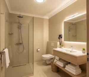 a bathroom with a sink and a toilet and a mirror at MyHome Apart Antalya in Antalya +7 photos