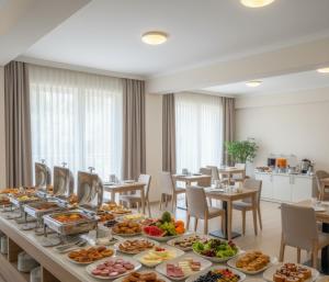 a long buffet of food on a table in a restaurant at MyHome Apart Antalya in Antalya