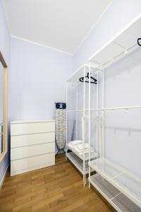 a room with white shelving and white shelves at Suite Andrea-Luxury Central Suite in Bergamo +3 photos