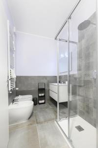 a bathroom with a tub and a toilet and a sink at Suite Andrea-Luxury Central Suite in Bergamo