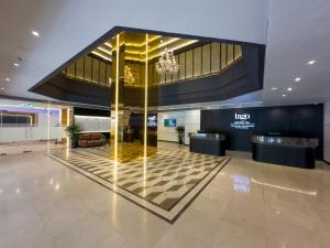 a lobby of a hotel with a checkered floor at Trigo Hotel Kuala Lumpur in Kuala Lumpur