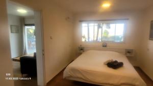 Un dormitorio pequeño con una cama con ventana. en Beit Nofesh, en Tiberíades 18 fotos más