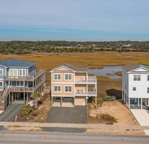 an aerial view of houses and a river at Second Row Stunning Ocean and Marsh Views in Holden Beach