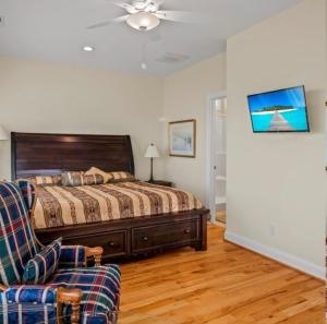 a bedroom with a bed and a couch at Second Row Stunning Ocean and Marsh Views in Holden Beach