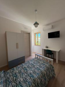 a bedroom with a bed and a desk in it at B&B Fior di Feruci in Trenta +14 photos