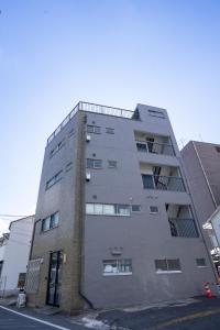 an apartment building on the corner of a street at MOMOYA tsudoi in Okayama