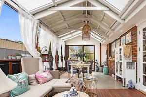 a living room with a couch and a table at Home of Susan Close in Narre Warren