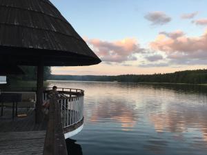 a person sitting on a dock next to a body of water at Mierki da Marco 