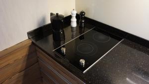a kitchen counter with a black counter top at Mierki da Marco  +15 photos