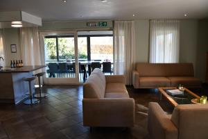 a living room with a couch and a table at La Bordure de la Forêt in Sourbrodt