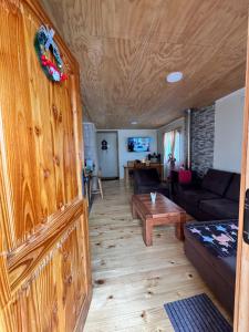 a living room with a couch and a table at Cabañas Campo Frutillar in Frutillar
