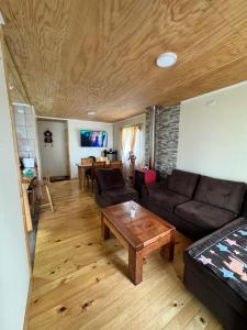 a living room with a couch and a coffee table at Cabañas Campo Frutillar in Frutillar