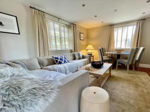 a living room with a couch and a table at Gilbertson Cottage in Wheldrake
