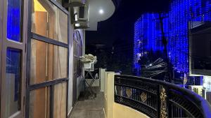 a balcony with blue lights on the side of a building at Varanasi Bliss Stay in Varanasi